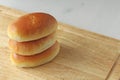 Russian traditional patties with egg and green onion lie on a wooden board. Delicious ruddy baked patties. Design with copy space Royalty Free Stock Photo