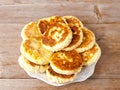 Russian traditional syrniki cottage cheese pancakes breakfast on the plate on wooden background