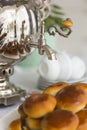 Russian traditional teaparty with samovar and pies or pirozhki with apple jam