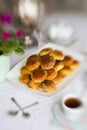 Russian traditional teaparty with samovar and pies or pirozhki with apple jam