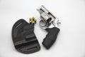 Traumatic Taurus revolver with clip on the white background