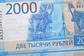 Russian two thousandth notes close-up against the background of a dark wooden table Royalty Free Stock Photo