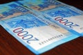 Russian two thousandth notes close-up against the background of a dark wooden table Royalty Free Stock Photo