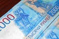 Russian two thousandth notes close-up against the background of a dark wooden table Royalty Free Stock Photo