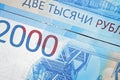 Russian two thousandth notes close-up against the background of a dark wooden table Royalty Free Stock Photo