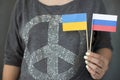 Russian and Ukraine flags and peace symbol on female shirt. Stop war concept. Russia Ukraine conflict