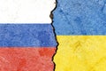 Russian and Ukranian flag on a cracked wall- politics, war, conflict concept