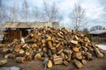 Chopped firewood stacked in one big pile for kindling and heating the Russian hut in the winter season. Royalty Free Stock Photo