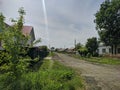 Russian village, a city road passes near houses in Kamen-na-Obi, Altai, Russia. View