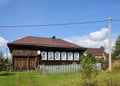 View of the old traditional wooden house with beautiful carved windows. Village of Visim, Sverdlovsk oblast, Russia Royalty Free Stock Photo