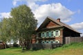 View of the old traditional wooden house with carved painted window shutters. Village of Visim, Sverdlovsk oblast, Russia Royalty Free Stock Photo