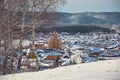 Russian village winter. Roofs covered with snow, a Blizzard sweeps in the forest Royalty Free Stock Photo