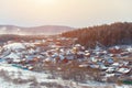 Russian village winter. Roofs covered with snow, a Blizzard sweeps in the forest Royalty Free Stock Photo