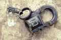 Russian vintage padlock with key on a background of stones