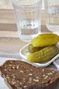 Russian vodka in glass with black bread and pickles cucumbers, vertical image