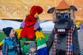 Russian winter holiday. The photographer takes pictures of the holiday. Young children are joyfully photographed next to a life-si