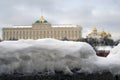 Russian winter. Huge snowhill. Moscow Kremlin at background. Color photo. Royalty Free Stock Photo