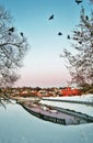 Russian winter scene. A pond partly frozen surrounded by the snow.