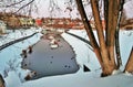 Russian winter scene. A pond partly frozen surrounded by the snow.