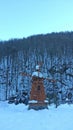 Russian winter, wooden windmill and snowy forest Royalty Free Stock Photo