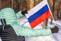 A Russian woman holds an open flag of Russia, Winter scenery, Russian national colors, Concept, manifesting attachment to the Royalty Free Stock Photo