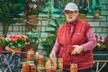 Russian woman selling rolled into cans vegetables (Kaluga region).