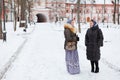 Russian women in winter clothes against church