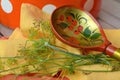 Russian wooden khokhloma spoon on orange napkin with fresh dill, russian style. A wooden spoon painted in Khokhloma style Royalty Free Stock Photo