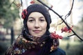Russian young woman under the rowan branch