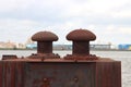 Rust-colored bollard for mooring ships in the port of Rotterdam in the netherlands