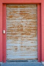 The rust corrugated grey metal door.