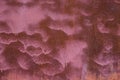 Rust in the form of waves on the pink-painted metal surface. Background, structure. Royalty Free Stock Photo