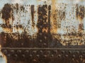 Rust metal texture with rivets, abstract grunge background Royalty Free Stock Photo