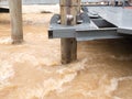 Rust roller support pole of pontoon in rapid stream flowing river