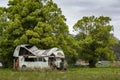 Rusted and abandoned bus or truck with severe roof damage Royalty Free Stock Photo