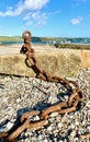 Rusted anchor chain snakes away from concrete block Royalty Free Stock Photo