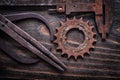 Rusted antique measuring calipers with cog- wheel on vintage dar Royalty Free Stock Photo