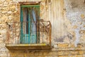 A rusted balcony on a rustic building in the hill town of Centuripe