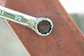 Rusted Bolt with chrome wrench