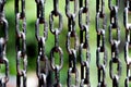 Rusted chain with black paint with Green nature background