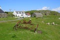 Rusted farm implements and houses