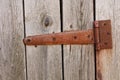 Rusted forged curtain on a wooden door. Part old wooden door. Barn. Cracked. The door to the hinges. Close Up of wood Royalty Free Stock Photo