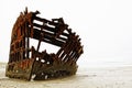 The rusted frame of the wrecked Peter Iredale rests in heavy fog on the northwest Oregon coast. Royalty Free Stock Photo