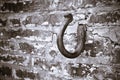 Rusted hook in a brick wall stone