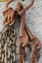 Rusted Hooks And Chains Hanging Against Cement Royalty Free Stock Photo