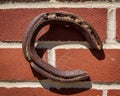 Rusted horse shoe on red brick wall Royalty Free Stock Photo