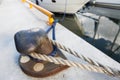 Rusted iron mooring bollard with rope on pier Royalty Free Stock Photo