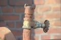 Rusted iron pipe with shut-off valve in an old factory