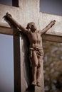 Rusted Jesus on the cross above a grave