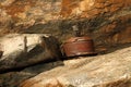 Rusted metal boat tie next to rock wall Royalty Free Stock Photo